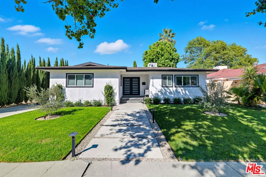 Welcome to this beautiful residence, nestled on a charming, tree-lined street in Tarzana. This stunning 3-bedroom, 2-bathroom home is a true gem. As you approach, you will be greeted by beautifully maintained landscaping that sets the tone for the elegance within. Step inside to experience open-concept living at its finest. The modern kitchen features a center island and sleek stainless steel appliances, seamlessly flowing into the inviting living and dining areas. Large, updated windows flood the space with natural light, creating a warm and vibrant atmosphere. The home boasts three bedrooms, including a lovely primary suite. The suite features a generous bedroom size, a beautifully updated bathroom, and an oversized walk-in closet. Venture into the backyard, a perfect setting for entertaining friends or enjoying a tranquil evening under the stars. With a generously sized yard adorned with maturing ficus trees and a cozy firepit at its center, relaxation is just a step away. Additionally, the garage has been transformed into a stunning gym/yoga studio. Don't miss the opportunity to make this lovely Tarzana  residence your own.