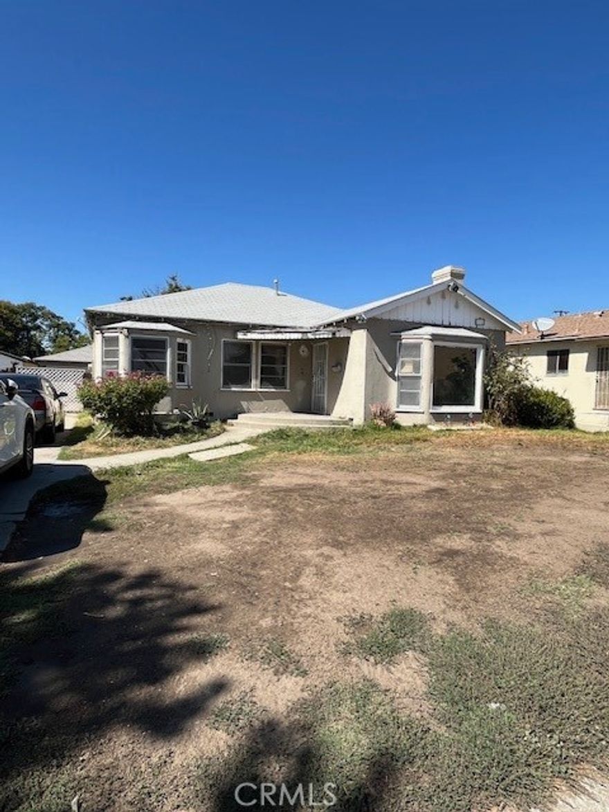 Excellent investment opportunity located in a commercial/residential zone in the heart of city of San Bernadino. The house is a two bedroom and one and a half bath that can easily make it as a business office/retail unit (check with city for detail) or as a residential unit with a generous 1282 sq ft inside and a large 8,000 sq ft lot for future expansion for either a commercial unit or a residential dwelling. A two car garage detatched. This is a fixer upper property and will sell it AS IS. Seller will not do any repair! Cash prefer !
