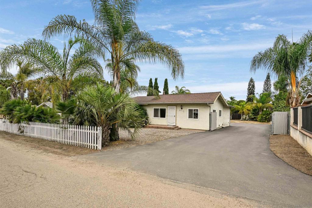 Welcome to this fantastic 3-bedroom, 3-bathroom single story home located in the desirable San Marcos School District! Offering comfort, functionality, and plenty of room to grow, this property sits on a large, flat lot with no HOA and a detached 2-car garage. Enjoy peace of mind with numerous updates, including newer central air, dual-pane windows, a fresh asphalt driveway with parking for more than a dozen vehicles, and remodeled primary and hall bathrooms. Enter to gaze upon gorgeous wood-look flooring throughout. The updated kitchen is perfect for meal preparation, and has direct access to a back patio and the detached garage. A large dining room just off the kitchen provides space to entertain. The spacious primary bedroom has great lighting with 3 large windows, and has plenty of extra space for exercise equipment or your home office setup! Unique features include a third bathroom located in the detached garage—ideal for hobbies, projects, or workshop use. The expansive backyard offers endless possibilities, with enough space to add an ADU, pool, or for storage of RVs, boats, cars, or equipment. Whether you're into hot rods, building projects, or simply need room to spread out, this property has it all.