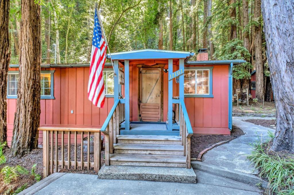 Timeless, vintage and immaculate storybook cabin sitting on almost 1/2 acre of flat redwood forest. Modern updates add comfort and ease of living while the antiquity of the original blown glass windows and redwood accents retain the character and charm. Multiple out buildings, a workshop already plumbed for an additional bath, a separate laundry and utility shed with beautiful stained glass windows and a custom wood shed to boot! Room for plenty of parking, RV, boat, toys. This is a very loved property and home, must see in person! This property neighbors the beautiful Loch Lomond Reservoir where boating, fishing, picnics and hiking are enjoyed.