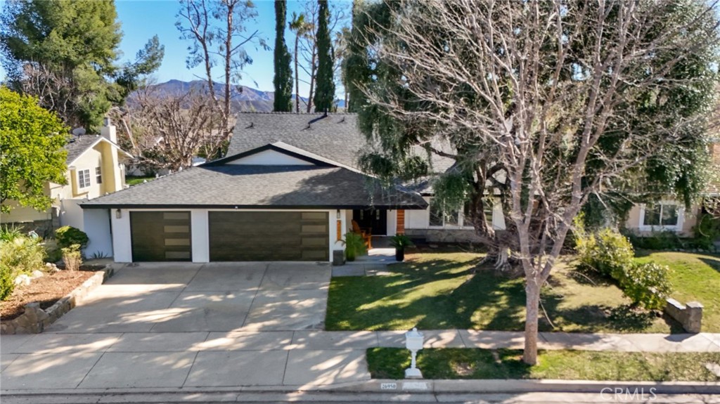 Offering exceptional value in Saratoga Hills, this updated Calabasas pool home blends modern comfort, style, and flexibility in one of the area's most desirable neighborhoods. The 4-bedroom, 3-bathroom residence offers 2,593 square feet of living space on a beautifully landscaped 7,300 square foot lot.
Featured on an episode of House Hunters, the home welcomes you with soaring vaulted ceilings, dual-pane windows, and luxury vinyl plank flooring. A sleek quartz-clad fireplace anchors the sun-filled living area, while the adjacent kitchen impresses with waterfall-edge quartz countertops, stainless steel appliances, a center island, and French doors leading to the backyard.
The private yard is a true retreat, featuring a pool, multiple seating areas, and mature landscaping—ideal for outdoor dining and entertaining.
The main level includes a guest bedroom and full bath, perfect for visitors, multigenerational living, or a home office. Upstairs, the expansive primary suite includes a fully permitted 400 sq ft addition, creating a flexible bonus area ideal for a nursery, gym, office, or potential fifth bedroom. A secondary bedroom offers the potential to be divided into distinct, multifunctional spaces, adding even more versatility. The spa-like ensuite bath boasts a soaking tub, walk-in shower, and dual vanities.
Additional highlights include recessed lighting, plantation shutters, a dedicated laundry room, and a spacious three-car garage with epoxy flooring.
Ideally located near Grape Arbor Park, award-winning Las Virgenes schools, and major commuter routes, this is a standout opportunity to own a thoughtfully updated home in the heart of Calabasas.