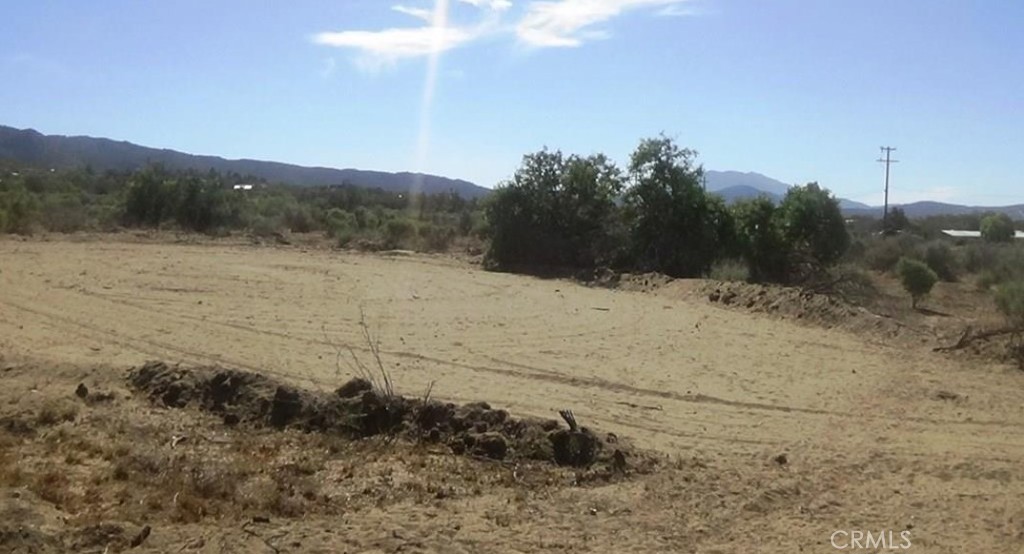 Beautiful 4.91 acre mostly flat and usable lot. The lot has 360 degree views of Mountains and valley and sits in a wonderful location in town with privacy yet not far from town or pavement. There is a small graded area to give you an idea of what your home site could look like. Perfect lot for anyone who wants the flexibility of a usable lot. This is one of four adjacent lots for sale ask your agent for a lot map and take your pick! The lot recently had all corners marked by a surveyor. Use caution when driving onto newly graded pad as soil is loose.