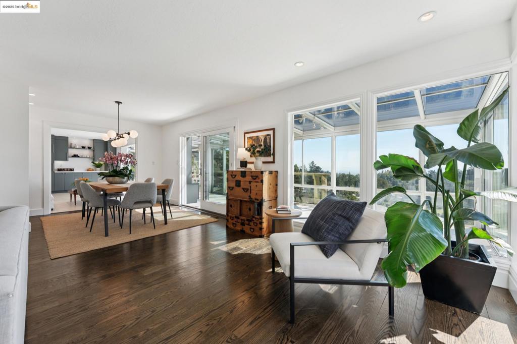 Modern Masterpiece moments from Montclair Village. This 3-bedroom, 2.5-bath residence combines everyday comfort, expansive rooms with exceptional entertaining spaces. Upstairs, a chef’s kitchen with walk-in pantry and premium appliances flows effortlessly into the living and dining areas, where hardwood floors and a striking fireplace create a warm centerpiece. A sunroom stretching the length of the home captures panoramic views of San Francisco, the perfect setting to relax or host. Downstairs, two generously sized bedrooms—including one with city views—are complemented by a serene, spa-inspired bath with designer finishes. The expansive primary suite is a true retreat, featuring a marble fireplace, luxurious en suite bathroom with jacuzzi tub, and a walk-in closet. Outdoors, the landscaped yard offers fruit trees, multiple seating areas, and a versatile bonus studio. Additional highlights include a two-car garage, abundant storage (including a large area beneath the home), and thoughtful modern updates throughout. Blending elegance, function, and convenience, this home offers a rare opportunity in one of Montclair’s most sought-after locations—just minutes to Village shops, dining, and scenic trails.