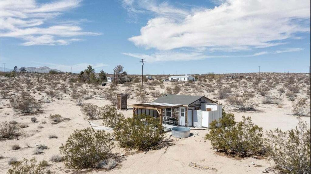 Perfect tiny mid-century retreat cabin in Joshua Tree featuring sweeping views on beautiful 5 acres with plenty of room to grow. Perched on a gentle slope that offers panoramic views. Meticulously remodeled with new kitchen, floors, ac, and refrigerator. Outdoor shower. Plenty of parking. Starry nights. Zoning and location allows for Horse property. 12.5 acres of open BLM space to the west for hiking and dog walking. Soak in the sun while cooling off in your cowboy tub and private outdoor shower. Slab patio with firepit and bbq. Hop into the hammock and take pleasure watching the roadrunners, quail, and jackrabbits frolic. 16 miles to the Joshua Tree National Monument. About 3 million tourists visit the park annually. Very hot vacation rental area. Not far from the JT Village to enjoy organic cafes, the farmers market, and the saloon. Zoning may allow for 2 homes and guest units buyer to verify. May be ideal to start a luxury compound. Plenty of room for parking, RVs and Airstreams. Not far from the Joshua Tree Lake Bed for off-roading adventures. Enjoy the peaceful serene vibes of rural living. Views of Mt. San Gorgonio and Mt San Jacinto. Vistas of Mt. Nebo, Copper Mtn, Mt. Bartlett, and the Little San Bernardino Mtns. 45 miles to Palm Springs. 63 miles to Big Bear Lake. 139 miles to Los Angeles. Make your dream come true. Don't Wait! - Call Now!