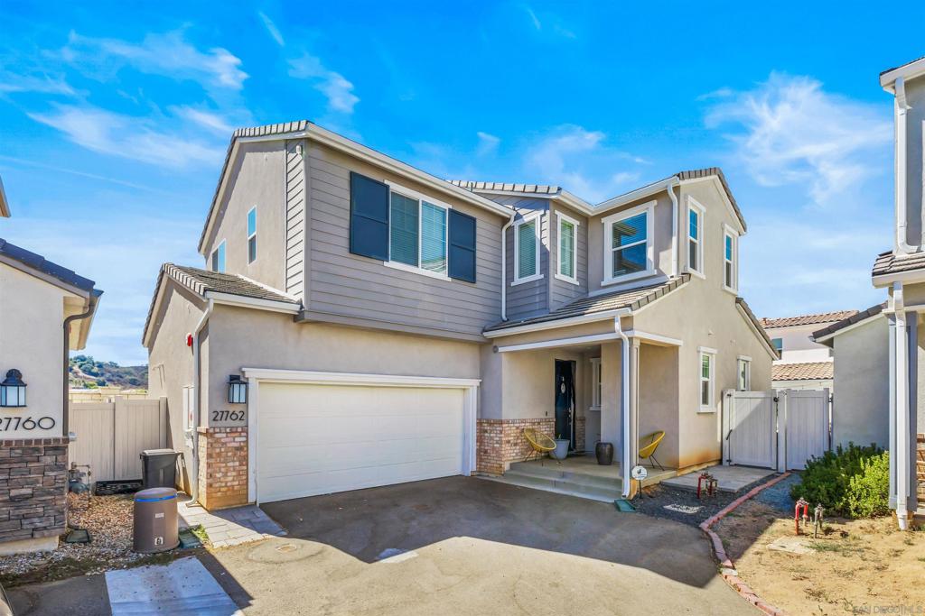 Welcome to your dream home in the scenic community of Valley Center! This beautifully designed residence offers four generously sized bedrooms and three full bathrooms—perfect for busy mornings and family life without the wait. One bedroom and a full bathroom are conveniently located on the main level, ideal for guests or multi-generational living. At the heart of the home is a spacious kitchen, the ultimate gathering spot for family and friends. Thoughtfully upgraded with a farmhouse sink, pull-out shelves, under-cabinet lighting, walk-in pantry and modern finishes, this kitchen is as functional as it is stylish. Its seamless connection to the dining area and living room creates an open, airy flow that’s perfect for entertaining or enjoying everyday moments together. Abundant windows bathe the interior in natural light, while roller blackout blinds allow you to set the mood with ease. Upstairs, a versatile loft provides a flexible bonus space—perfect for a home office, playroom, or media area. The primary suite offers a peaceful retreat with plenty of room for rest and relaxation. Its spa-like en suite bathroom features a dual vanity, garden tub, step-in shower with rain showerheads, and a generous walk-in closet. This smart home comes fully equipped with owned solar, a whole-house fan, whole-house water filtration, a tankless water heater, sound system, and a security system for modern comfort and peace of mind. Over $100,000 in upgrades include sleek modern railing, soundproof insulation between floors, holiday lights outlet package, epoxy-coated garage floors, and energy-efficient features designed for convenience and sustainability. Meander outside to your private backyard oasis, complete with a paver patio, extra space for gardening and play, and an app-controlled in-ground pool/spa—perfect for soaking under the stars. Life in Park Circle comes with an array of resort-style amenities at Harvest Park. Residents enjoy a sparkling pool and spa, lush green spaces, playgrounds, scenic trails, bocce ball, sport court, and a clubhouse complete with a fully equipped kitchen, fitness center, and a covered outdoor lounge with a cozy fireplace. This incredible Valley Center home is the perfect blend of style, comfort, and state-of-the-art living—truly a must see!