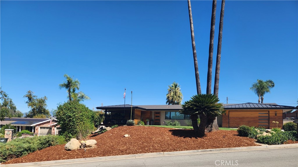 Let’s just call it Mid Century Modern MAGNIFICENT! The minimalist aesthetic and clean forms make this a classic choice in sleek and functional architecture connected to the outdoors looking out over the 11th fairway of Redlands Country Club. Appealing features of this 2900 sq. ft. home include an open relaxing floor plan with high, beamed ceilings, a magnificent gas fireplace, granite kitchen counters and center island, top of the line stainless appliances, self-closing cabinets, a 6 burner cook top, double oven, warming drawer, and 2 sinks, all joined by a butlers pantry with abundant storage. The light and airy 4 bedrooms and 4 baths are complimented by the high-quality quartz counter tops, exciting tub and shower designs, warm color accents. and earthy stone and tile tones. The east wing bedroom is its own private suite with walk in shower. Enjoy the golf course views including the one from your private office and dining room, both connected to your entertainment balcony. The laundry area is big enough to use as a craft or hobby area with no lack of storage and shelving. You will appreciate all the amenities which just keep you amazed at the thought and creativity that went into this modern transformation. Of course, the back yard and pool are just the place to enjoy the outdoors and entertain family and friends. Some noted items of interest which often go unnoticed are the dual zoned HVAC system, 2 tankless water heaters, clean ozone pool water treatment, extra parking, oversized 2 car garage, and more!