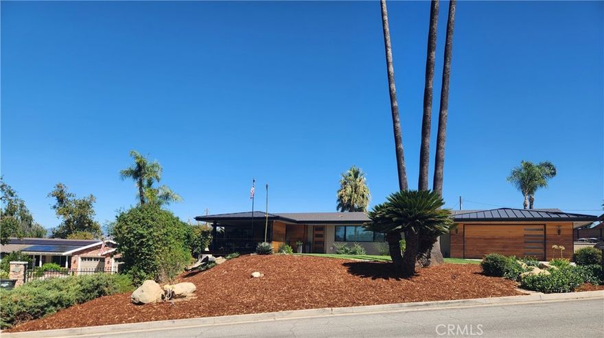 Let’s just call it Mid Century Modern MAGNIFICENT! The minimalist aesthetic and clean forms make this a classic choice in sleek and functional architecture connected to the outdoors looking out over the 11th fairway of Redlands Country Club. Appealing features of this 2900 sq. ft. home include an open relaxing floor plan with high, beamed ceilings, a magnificent gas fireplace, granite kitchen counters and center island, top of the line stainless appliances, self-closing cabinets, a 6 burner cook top, double oven, warming drawer, and 2 sinks, all joined by a butlers pantry with abundant storage. The light and airy 4 bedrooms and 4 baths are complimented by the high-quality quartz counter tops, exciting tub and shower designs, warm color accents. and earthy stone and tile tones. The east wing bedroom is its own private suite with walk in shower. Enjoy the golf course views including the one from your private office and dining room, both connected to your entertainment balcony. The laundry area is big enough to use as a craft or hobby area with no lack of storage and shelving. You will appreciate all the amenities which just keep you amazed at the thought and creativity that went into this modern transformation. Of course, the back yard and pool are just the place to enjoy the outdoors and entertain family and friends. Some noted items of interest which often go unnoticed are the dual zoned HVAC system, 2 tankless water heaters, clean ozone pool water treatment, extra parking, oversized 2 car garage, and more!