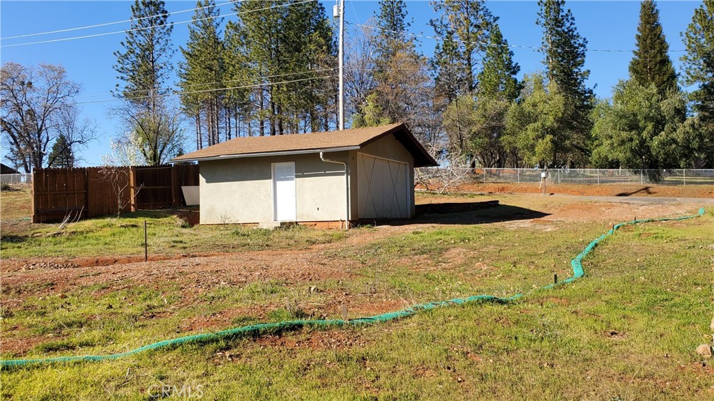 DETACHED 2-CAR GARAGE ON A LOVELY, LEVEL .33 ACRE LOT! Lower Paradise Location with a lovely lot with fruit trees, sunshine and garden space, a good amount of the fencing still in place, plus the driveway and the retaining wall alongside the garage that creates some extra parking space. This is a beautiful lot that previously had a 1050 square foot, 2-bedroom home and is in walking distance to the Paradise Performing Arts venue and just minutes away from several shopping centers and the downtown parks! Such a great place to build your new home and an easy commute to Chico or Oroville. All this without of the congestion of the bigger cities and offering that peaceful small-town vibe!