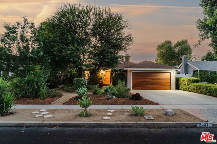 This updated and lovingly cared-for mid-century ranch jewel greets you with its lush, drought-tolerant front yard alive with color, studded with lime, plum, and pomegranate trees, all enveloped by a glorious chilean mesquite. Step inside and bask in the sun-filled living room with picture windows, a wood-burning fireplace, as stunning refinished original oak hardwood floors flow throughout. Updates & energy savings: OWNED PAID OFF SOLAR, newer HVAC, newer roof and garage door, Level 2 EV fast charger, copper plumbing, attic insulation, nest thermostat, water filter, and an upgraded 200-amp panel to mention a few.The remodeled kitchen features stone counters, updated cabinetry with organizer pullouts, newer appliances, dining area and separate breakfast bar that opens to the living room, perfect for morning coffee or lively evenings. The floor to ceiling pantry and laundry room are located just off the kitchen, replete with storage. A thoughtful floor plan offers one bedroom up front with en suite bath, and two more tucked down their own private wing all with ample closet space and hall storage. The baths have been updated, including the full bath with dual-sink vanity and Rejuvenation finishes. The designer landscaped backyard reveals a sanctuary of fruit trees gathered around a flowing fountain, all growing in your own private garden of eden. Here, twilight suppers and mornings on the porch are memories waiting to be made. Summer BBQs under the twinkle lights await while there's still plenty of room for a pool or spa in your privacy-landscaped generous sized lot, not to mention the chic storage shed to store all your gardening needs. The finished 2-car garage offers flexibility of use for parking, a home gym, or studio, or explore your options as future rental as it has its own detached entrance (buyer to research options with LA City/LADBS). All just minutes from great grocery stores, shops, dining, and brand new theaters at Westfield Topanga & The Village (hello Costco!), yet tucked away in the serenity of its cozy Sunnybrae neighborhood. Welcome home!