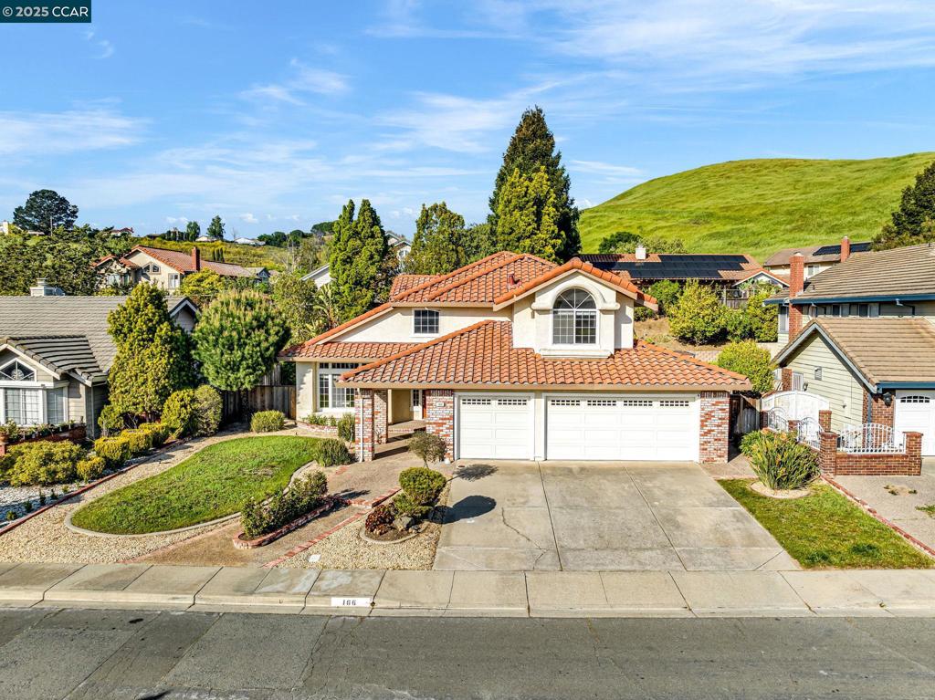 Welcome to 166 Shepard Street in the heart of Hercules — where comfort meets elegance in this beautifully designed 4-bedroom, 3-bath home spanning 2,519 sq ft on a generous 7,000 sq ft lot. Built in 1989, this spacious residence offers timeless charm with thoughtful updates and a layout ideal for both everyday living and stylish entertaining. The main floor features a convenient bedroom and full bath, perfect for guests or multigenerational living. Upstairs, you’ll find three additional bedrooms, including a Jack-and-Jill bathroom and a serene primary suite complete with a large walk-in closet and a luxurious soaking tub for ultimate relaxation. Entertain with ease in the formal dining room or gather around the cozy fireplace in the family room. The cathedral ceilings in the living room create an airy, grand atmosphere, while the breakfast nook offers a casual space for morning coffee or weekend brunch. Step outside to your private, low-maintenance backyard, featuring a charming gazebo, ideal for outdoor dining or lounging with friends and family. A three-car garage provides ample storage and parking. This is more than a home — it’s your personal retreat in one of Hercules’ most desirable neighborhoods.