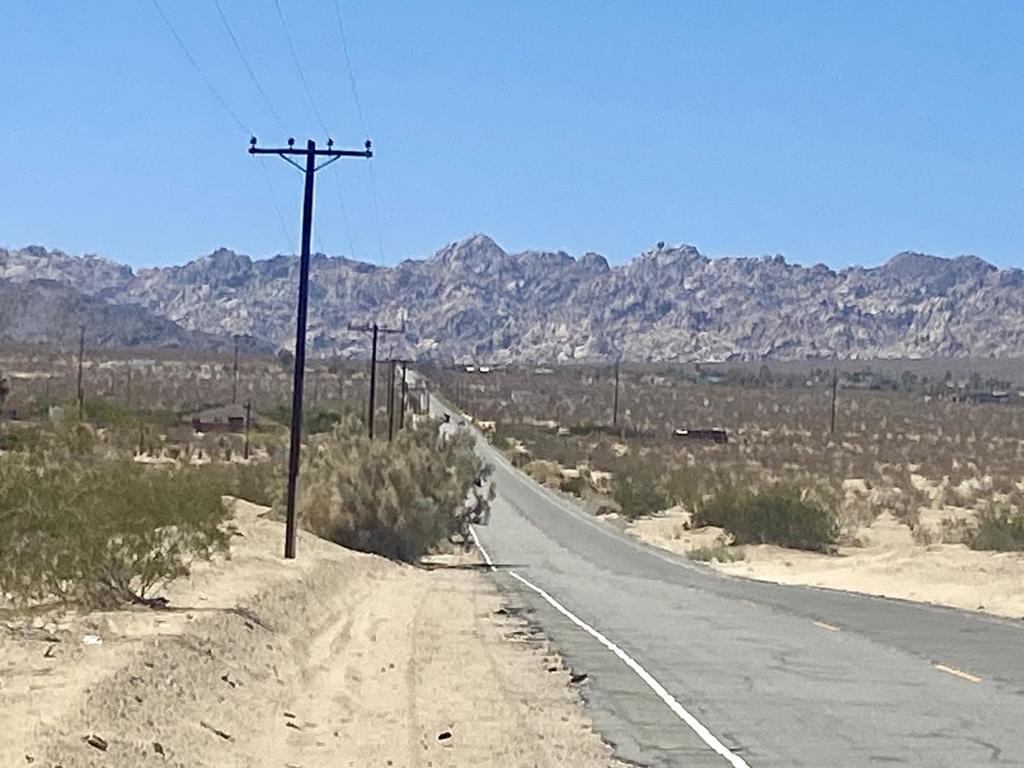 Amazing Vistas!!! Corner lot with pavement along Lear Ave and dirt road along Barnes Road. Views of Indian Cove, the Little San Bernardino Mtns, and Copper Mtn. 5.03 acres relatively flat, in a private setting. Property may allow up to three dwellings including an ADU. Build the dream compound you've always wanted. 3.5 miles to the magical boulder cliffs of Indian Cove. 7 miles to Copper Mtn College. Joshua Tree National Monument is only 13 miles to the 29 Palms gate. 17 miles to the JT West entrance gate. Very hot vacation rental area. About 3 million tourists visit the National Monument annually. Not far from the trendy JT Village with organic restaurants, cafes, the farmers market, & JT Saloon. Downtown 29 Palms offers more cafes, a playhouse theatre, casino, the new Freedom Plaza Mall & the ancient oasis at the 29 Palms Restaurant & Inn. Enjoy the mid winters. Watch the jackrabbits, quail, and roadrunners traverse the open spaces. 46 miles to Palm Springs. 139 miles to Los Angeles. West Desert Heights is one of the most beautiful, and convenient, pockets of 29 Palms. Buyers must contact the city of 29 Palms planning department with all questions on building and uses and total dwelling allowance. Buyers must contact the utilities agencies with questions and verifications of utilities. Address is real. APN: 0612-061-01-0000 GPS: 34.16001, -116.14958 Property on S/W corner of Barnes and Lear.