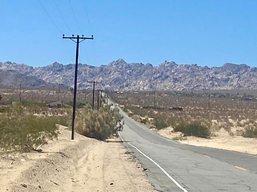 Amazing Vistas!!! Corner lot with pavement along Lear Ave and dirt road along Barnes Road. Views of Indian Cove, the Little San Bernardino Mtns, and Copper Mtn. 5.03 acres relatively flat, in a private setting. Property may allow up to three dwellings including an ADU. Build the dream compound you've always wanted. 3.5 miles to the magical boulder cliffs of Indian Cove. 7 miles to Copper Mtn College. Joshua Tree National Monument is only 13 miles to the 29 Palms gate. 17 miles to the JT West entrance gate. Very hot vacation rental area. About 3 million tourists visit the National Monument annually. Not far from the trendy JT Village with organic restaurants, cafes, the farmers market, & JT Saloon. Downtown 29 Palms offers more cafes, a playhouse theatre, casino, the new Freedom Plaza Mall & the ancient oasis at the 29 Palms Restaurant & Inn. Enjoy the mid winters. Watch the jackrabbits, quail, and roadrunners traverse the open spaces. 46 miles to Palm Springs. 139 miles to Los Angeles. West Desert Heights is one of the most beautiful, and convenient, pockets of 29 Palms. Buyers must contact the city of 29 Palms planning department with all questions on building and uses and total dwelling allowance. Buyers must contact the utilities agencies with questions and verifications of utilities. Address is real.  APN: 0612-061-01-0000 GPS: 34.16001, -116.14958 Property on S/W corner of Barnes and Lear.
