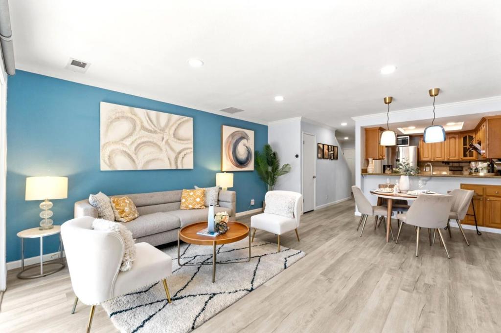 Welcome to this beautifully upgraded 2-bedroom, 1.5-bath townhouse in vibrant Campbell. A rare PUD with a spacious south-facing backyard, this home offers 1,152 sq. ft. of comfortable living space and lives like a single-family home. The kitchen is updated with sleek stainless steel appliances, making cooking a delight, while the open-concept dining and living areas create a warm, inviting atmosphereperfect for entertaining. Enjoy cozy evenings by the fireplace, surrounded by tasteful two-tone paint and accent walls. Both bathrooms have been thoughtfully updated, and the mix of laminate and tile flooring throughout offers style, durability, and low maintenance. Smart-home upgrades include automated curtains, thermostat, and lighting. A washer and dryer are also included for your convenience. Practicality meets comfort with forced-air heating, a 1-car attached garage plus an additional assigned parking space. Tucked quietly off the street, this home provides a private retreat while still being close to Campbells lively shops, dining, and commuter routes.