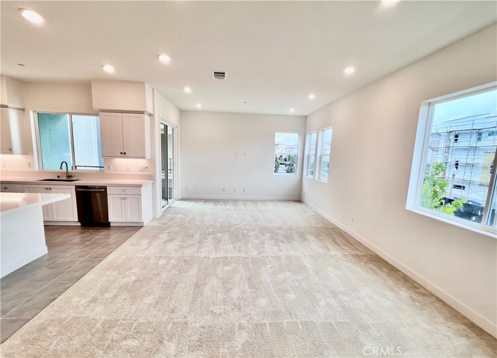 Welcome to 215 Sash, Irvine A 2023 newly built modern home in the prestigious Great Park community. This end unit residence offers 4 bedrooms and 4 bathrooms, with a versatile layout designed for modern living. First Floor: Garage and direct access to the main floor, Second floor: A private bedroom with full bath, perfect for guests, in-laws, or a home office. Bright and expansive open-concept living room with high ceilings, a modern kitchen with large island, a spacious dining area, and a family room that flows seamlessly to a balcony with neighborhood views. Third Floor: Retreat to the luxurious primary suite with spa-inspired bath and private balcony overlooking city lights and park, plus two secondary bedrooms. This home is filled with natural light, upgraded finishes, plush carpeting, and modern touches throughout. Both balconies provide a wonderful extension of indoor living with views of the community and beyond. Residents of the Great Park community enjoy resort-style amenities, including pools, spas, playgrounds, sports courts, and endless walking trails. Conveniently located within walking distance to top-rated Irvine schools, parks, and shopping, with quick access to the Irvine Spectrum, 5, 405, and 133 freeways. This is a rare opportunity to lease a nearly new home in one of Irvine's most desirable locations.