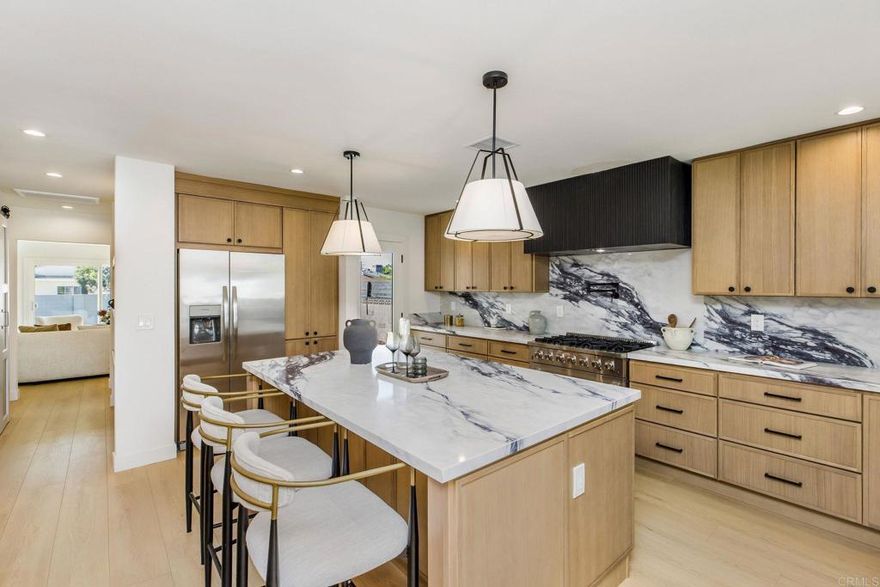 This stunning, fully remodeled gem sits on a quiet, tree-lined street in the heart of Sherman Oaks. Every detail has been thoughtfully updated for modern comfort and timeless style—from the shiplap-clad fireplace wall in the family room to the dramatic marble-style kitchen backsplash, with designer lighting throughout.   An open, sun-filled layout welcomes you in, with beautiful new flooring flowing through spacious living areas, anchored by sleek stucco fireplaces.  The chef’s kitchen features warm white-oak shaker cabinets, stainless steel appliances, a pot filler, and a large island that’s perfect for gatherings. In the family room, a stylish dry bar adds a touch of luxury, and sliding doors open to a private backyard for effortless indoor-outdoor living.  The serene primary suite offers direct backyard access and a spa-inspired bathroom with designer finishes. Two additional bedrooms are bright and versatile, and the fully remodeled hall bath features custom tile, brushed gold fixtures, and a chic vanity.  Outside, lush new landscaping and fresh sod enhance the curb appeal, while the backyard’s  low-maintenance turf creates a tranquil retreat. The finished detached garage with wall A/C makes the perfect home office, gym, or studio.  Located near top-rated schools, parks, and local shops, this home offers the perfect blend of style, function, and the very best of Sherman Oaks living. Come see for yourself!