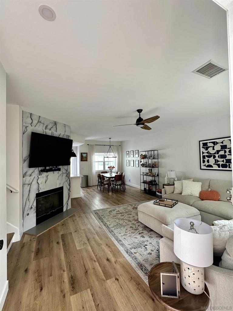 Live your best life at Scripps Townhomes! Imagine sitting on the idyllic rocking chair front porch with your favorite beverage soaking in the gorgeous San Diego weather all year round. Enter to gaze upon soaring vaulted ceilings over an open floor plan adorned by vinyl plank flooring throughout. Seamless daily living will be yours as the living room, dining room and kitchen flow effortlessly together. A stunning fireplace in the living room will be your favorite place to relax and unwind.  New Windows, Light filtering shades were added downstairs to keep the interior temperature comfortable. In 2022, the kitchen was re-imagined to feature crisp, white cabinetry, new stainless steel appliances, quartz countertops and modern accent lighting. Dine al fresco on the back patio. The half bath on the main level has been upgraded with modern flair. Both bedrooms are on the upper level, have upgraded ensuite bathrooms and recently had high-quality black out shades added. A built-in work center in the upstairs landing will help you stay productive when at home. The attached two car garage makes parking a breeze and a ceiling storage rack helps with the holiday decorations. 2023 Full size stacked washer/dryer conveys. A new roof was installed in 2021-2022 and the unit was fumigated in 2023. Scripps Townhomes is a serene, park-like community offering its residents tennis courts, a sparkling pool and a park. Great schools, shopping, dining and entertainment venues are nearby. This truly is an opportunity you do not want to miss!