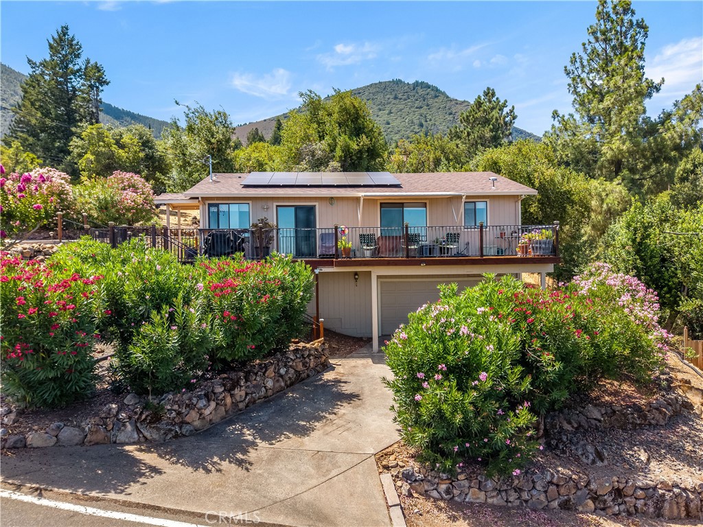 Turn-key lakeview home in Riviera West! Move right on in, well maintained, one level living 3bed/2bath, 1700sqft home located on a nice corner lot with bonus level parking for additional cars or your boat. Lots of value here with OWNED solar system that transfers with sale, as well as a full Generac whole home generator system! Real oak flooring, updated windows/window coverings, freshly stained newer front deck to take in the fantastic lakeview! Recently renovated kitchen with high end carbon colored stainless steel matching appliances, stone counters, and a lakeview from the kitchen sink. Lower level 2 car garage with extra storage. Pretty, low maintenance landscaping surrounds home. Great place for part time lake getaway home or for full time living! Located in one of the nicest HOAs around (only $455 a YEAR) for access to boat launch/marina across road, clubhouse and a beautiful community pool!
