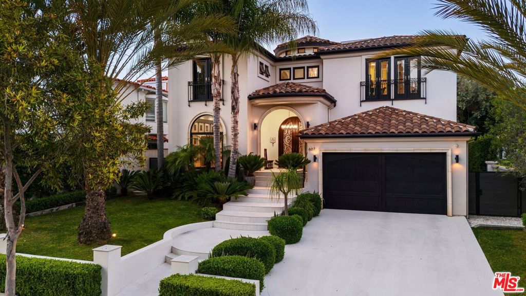 ***SELLER WANTS IT SOLD*** PRICED TO SELL. Stylish designer Spanish transitional home set on 26th. Framed by large palms and mature landscaped, for ultimate privacy. Upon entry, the high ceilings, archways, luxurious lighting fixtures, and abundant natural light immediately impress. A grand foyer leads to a formal living room on the left, highlighted by a fireplace and an oversized arched window. Continuing down the hallway, a wrought iron spiral staircase and a dramatic designer chandelier spanning two stories draws the eye. To the right, an office/library is accessible through double doors. The rear of the main level is the heart of the home, featuring the kitchen, dining room, and family room. The chef's kitchen boasts Thermador stainless steel appliances, waterfall quartz countertops, an oversized island with contemporary gold pendant lighting, a built-in Miele coffee machine, custom cabinetry, and even bar seating. The kitchen flows into the formal dining room, which seats six and opens to the yard through glass French doors. The spacious main living room, with a Parisian-style mantel and fireplace framed by a marble accent wall, feels open and airy, perfect for entertaining and everyday living, thanks to multiple windows and a large sliding glass door leading to the yard. Upstairs, skylights, an arched ceiling, and a spacious landing create a sense of openness. This level houses the lavish primary suite and three additional bedrooms. The grand primary suite features dramatic ceilings, a lounging/reading area, access to a large private outdoor terrace, a newly upgraded bathroom, and a walk-in closet. The modern spa-like bathroom includes an oversized dual floating vanity, ambient lighting, frameless glass shower, heated towel rack, a separate beauty/vanity area, and access to the walk-in closet. The three additional bedrooms each have private balcony/outdoor access, with two sharing a Jack and Jill bathroom and one with its own full bathroom, all finished to the same high standard as the primary suite. The lower level is ideal for entertaining, complete with a full-sized wine refrigerator, an additional built-in fridge and freezer, and media/viewing room. Two additional bedrooms and full bathrooms complete this lower level, which also has access to the backyard. The resort-like setting is a mecca for relaxation and entertaining, featuring a covered seating area overlooking the pool and jacuzzi, all enclosed by tall, oversized hedges for ultimate privacy. 607 26th Street is a rare find in the North of Montana area, updated to the nines with designer finishes at every turn and just minutes from shops, restaurants, and the beach!