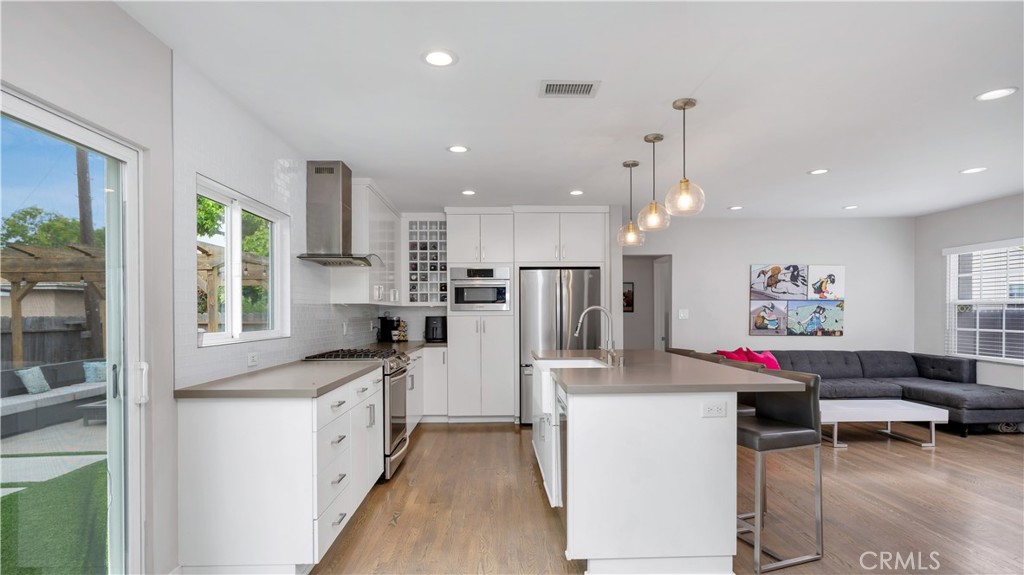 Location, Luxury and Lifestyle...Welcome home to this smartly designed and remodeled 4B/2B home at 5202 E Conant Street in the coveted South Of Conant neighborhood on a beautiful, lush green-belt median divided street. Current owners spent over $163K in 2019 in the vigorous pursuit of redesigning/upgrading and updating this home into a modern, clean and comfortable, stress-free home to love and to proudly share with others. You'll quickly agree that it is perfect for hosting gatherings or enjoying quiet fireside moments while achieving low maintenance demands. The electrical, plumbing, structural, foundational reliability and functionality features of this nearly 1,500 sqft inviting home will kindly reap you rewards of safety, security, comfort and genuine happiness for years to come. It boasts claim to its unique and smartly redesigned open-concept by stylishly creating a more architecturally pleasing flush-beam look interior, not seen in many Flips, for a clean consistent look with a massive island centerpiece and counter seating for four or five. The thoughtful ingenuity and robust structural improvements and earthquake retrofit bolting to the foundation of this home along with upgraded 200-amp electrical service panel and highly efficient 5.27 kW DC Solar System with 17 Solar panels, which produce an estimated 7,900 kWh per year, make this opportunity a rare one to proudly and confidently own. From the new insulation, all new interior doors, hardwood floors, new 200 AMP Electrical Service Panel, European-style cabinets, Pental Paloma Honed Quartz Countertops, Iconic Banquette-style Dining Room with stylish bench seating offering a comfortable and intimate dining experience, Kraus Oletto Kitchen faucet, deep Swiss Madison Delice Porcelain Single-basin Farmhouse Sink, Under Cabinet Lighting, Built-in Wine rack storage, two return intake HVAC ducts for greater efficiency and temperature continuity, Baldwin Prestige Collection Spyglass Locksets, and the strength, security and energy efficiency of your Therma-tru fiberglass exterior doors, Strength and Resiliency are evident throughout. Modernity meets Innovation here. Additional Amenities Abound; an efficient "whole house" fan, custom no-maintenance landscaping, easy touch window blinds, side-by-side parking, complete with all your needed SS appliances. Don’t miss the opportunity to own and enjoy this remarkable home.