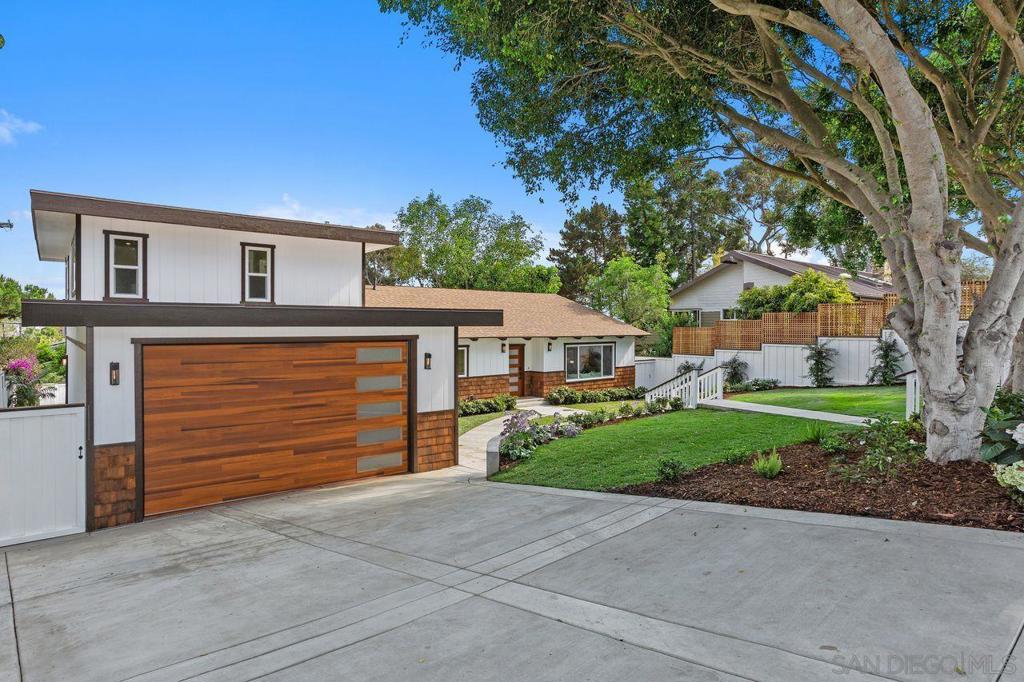 Welcome to your dream coastal retreat! Nestled on a generous 9,900 sq ft lot, this exquisitely remodeled 4 bed, 3 bath mid-century modern home offers 2,128 sq ft of elegant living space, timeless design, and thoughtful functionality. Vaulted wood-beamed ceilings and walls of windows flood the open-concept interior with natural light, creating a warm, airy atmosphere. The designer kitchen is a showstopper, featuring custom cabinetry, a waterfall island with slatted wood detail, professional-grade appliances, and sleek gold-accented fixtures. The adjacent dining and living areas open seamlessly to the lush front and rear yards. The flexible layout includes a main-level ensuite bedroom—perfect for guests or multigenerational living—plus an expansive upstairs primary suite with a walk-in closet and jack-and-jill vanities. A large upstairs loft offers additional living space or work-from-home potential and opens to its own private balcony. In total, the home features three balconies, each providing unique vantage points, including peek-a-boo views of the bay and ocean. Step outside to your private outdoor oasis: a sparkling pool, multiple patios for entertaining, mature landscaping, and a grassy yard with room to build an ADU. The oversized 3-car garage features a 9-foot high door, perfect for Sprinter vans, boats, or trailers. Located in a peaceful, tree-lined neighborhood just minutes from the coast, this one-of-a-kind property offers style, flexibility, and the ultimate Southern California lifestyle.