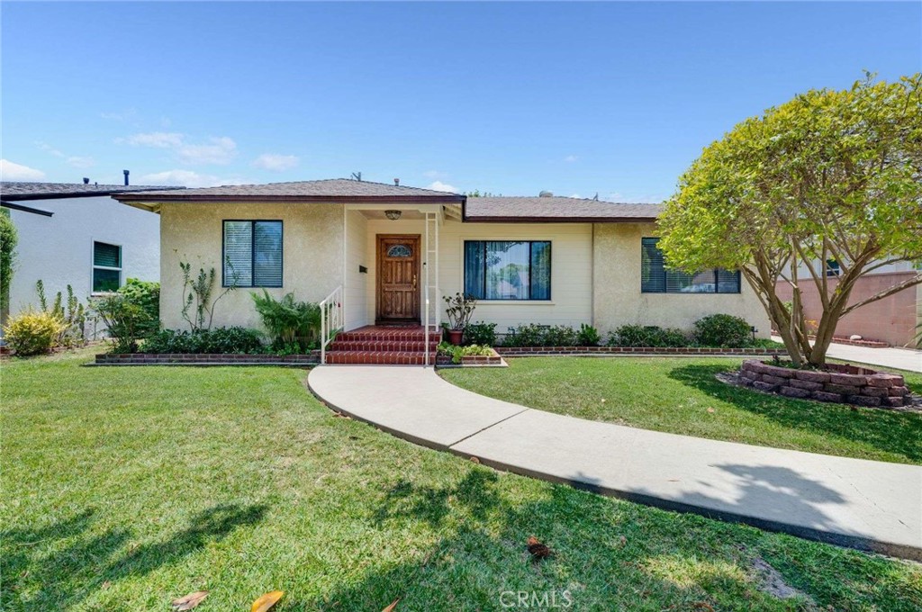 Step into comfort and style with this inviting home featuring newer plank flooring and a bright living room with a large picture window. This three-bedroom, two-bath home features an abundance of natural light, creating a welcoming space. The kitchen features ample counter space and ample wood cabinets, allowing easy meal preparation, alongside a dining area. A spacious family room features open-beam ceilings, a stone fireplace, and sliding glass doors that open to a covered patio—ideal for seamless indoor-outdoor living. The primary bedroom easily accommodates a king-sized furniture and is located at the rear of the home, offering privacy. Enjoy year-round comfort with central air and heat. Upgrades include fresh interior paint, baseboards, and recessed lighting. The long driveway provides ample parking and leads to a two-car garage. Premium lot size of 6006 sqft. This home is in the Carver Elementary boundary. Great location near several golf courses, bike paths, and El Dorado Park.