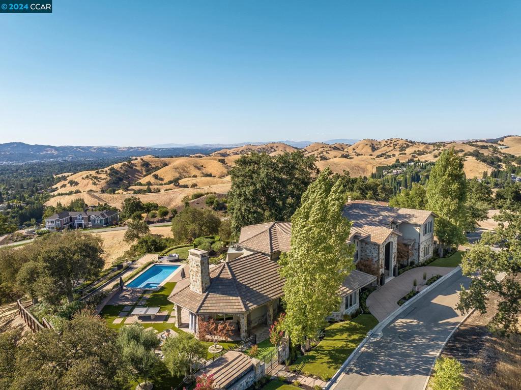 Welcome to the crown jewel nestled atop Legacy Ridge, a modern masterpiece in this private enclave of VIEW homes.This exquisite home boasts an impressive 7174 sq. ft. of unparalleled luxury & comfort with its meticulous design and attention to detail, all on a sprawling 2.8 Acre lot. Step inside to discover a breath-taking, recent remodel that’s transformed this residence into a turn-key, essentially new home. Kitchen features custom rift oak cabinets, natural quartzite slabs, SS appliances & a hidden pantry room. An open floor plan & soaring ceilings create a seamless flow, with bi-fold walls of glass that open to serene views & western sunsets, creating the perfect setting for both entertaining and everyday living. Mesmerizing 360-degree views of the surrounding mountains & panoramic vistas showcase the sunrise to the east. Entertain w/a temp-controlled wine room, media room, great room/game room & music room. Wake up daily to the ever-changing seasonal views. Outdoors, beautifully landscaped grounds offer a private oasis for relaxation & recreation w/pool, spa, multiple patios w/firepit, BBQ area, play area, bocce ball, viewing deck & Heritage Oak trees is perfect for enjoying the California sunshine. Come experience luxury living at its finest. Custom garage with lifts. Views: Ridge