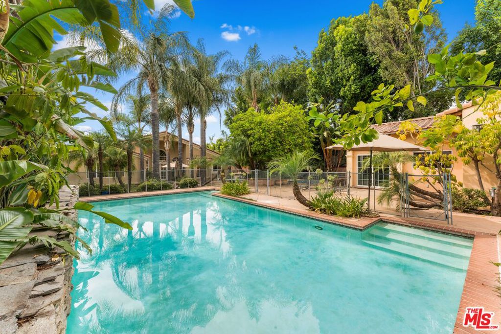 This remarkable residence, thoughtfully rebuilt in the early 2000s, combines elegance, comfort, and versatility in one of the Valley's most sought-after locations. The main home offers 5 spacious bedrooms and 5 bathrooms, with soaring high ceilings that create a sense of openness and light. Each room is thoughtfully designed, oversized, and inviting, making the home ideal for both everyday living and entertaining.An added bonus to this property is the private 2-bedroom, 1-bath ADU spanning 700 sqft. Perfect as an in-law suite, nanny quarters, or private space for household staff, it extends the home's functionality while maintaining comfort and privacy for all.The heart of the home is the chef's kitchen, outfitted with professional-grade appliances to inspire culinary creativity. Just beyond, the living room is warmed by a fireplace, offering a cozy space to gather with loved ones.Step outside into a backyard that feels like a private resort. A sparkling pool and jacuzzi invite relaxation, while the basketball court and expansive lawn create endless opportunities for recreation. A built-in BBQ makes outdoor entertaining effortless, and with RV access, the property is as practical as it is beautiful.The location could not be more idealjust a short stroll to Ventura Boulevard, where fine dining, boutiques, and shopping destinations like Trader Joe's, Sephora, and a nearby synagogue await. Whether it's relaxing at home or enjoying the surrounding neighborhood, this property offers the best of both worlds.Unfurnished and ready for immediate lease, this home is designed for those who seek space, versatility, and an elevated lifestyle.