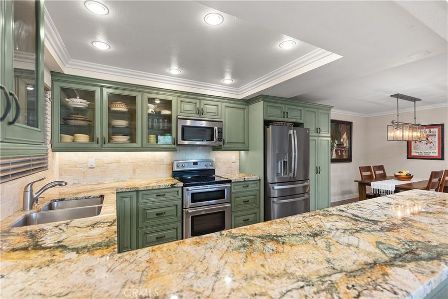 This two-bedroom, two-bathroom condo offers approximately 1,077 square feet of living space. The single-level home is situated within the Laguna Woods 55+ gated community and features the Casta Vista model(lower level).The remodeled kitchen showcases updated finishes and fixtures, providing a functional and modern cooking space. Laminate flooring flows throughout the home. The water heater is newer. Two AC split units have been included for your comfort. The upgraded bathrooms incorporate stylish elements, enhancing the overall comfort and convenience of the home.From the property, residents can enjoy a view of the surrounding hills, offering a tranquil and scenic outlook.  Additionally this home is located towards the end of a cul-de-sac. The well-maintained community amenities and secure gated environment contribute to a comfortable and carefree lifestyle. Amenities include:  6 clubhouses, 5 swimming pools, Performing Arts Center, fitness centers, tennis, bocce ball, pickle ball, art(pottery, photography, glass, lapidary, jewelry, painting) and so much more!
