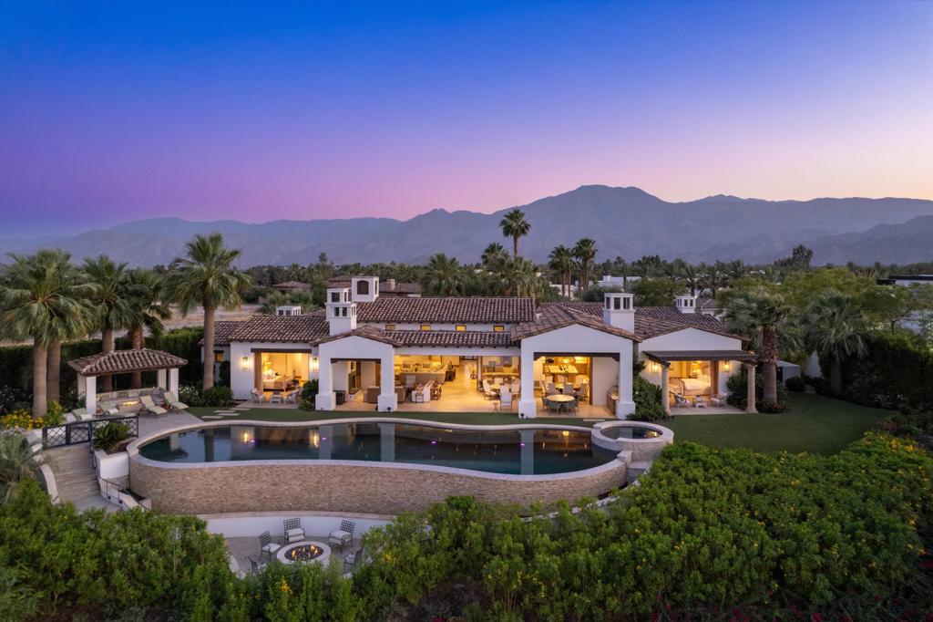 Welcome to this contemporary Mediterranean estate perfectly situated on an interior lot at the end of a cul-de-sac and perched atop the World Class Tom Fazio golf course at The Madison Club. The open floor plan and indoor/outdoor living areas lend themselves to functionality with an emphasis on style and comfort. Features like the luxury spa-like primary suite and 3 additional suites including a fully self-contained guest casita with kitchenette add to the overall appeal of this home. Attention to detail is showcased in the floor to ceiling pocket doors, bar, wine cellar, office, a sparkling infinity edge pool, spa, inviting gazebo, and countless firepits. The outdoor patio is the perfect place to enjoy views of the golf course, the mountains and amazing desert sunsets at your private sanctuary in The Madison Club.