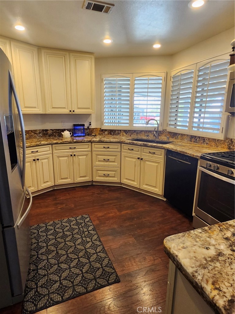THIS IS A MUST SEE! Presenting one of the larger homes in 'Plantation on the Lake' and situated on a desirable corner lot with a 2-car garage. Welcome to a Premier 55+ Community with Resort Style Living and countless amenities. The recently remodeled Kitchen features soft close drawers and doors. All lower cabinets have slide out drawers for shelves, with a Lazy Susan in the lower cabinet next to the oven, along with recessed lighting. The Breakfast Bar which connects the Kitchen and Family Room, creates an open concept living space. This is perfect for entertaining, especially with the inviting Fireplace and built-in Wet Bar in the Family Room. There is also an inset Workstation in the Family Ro.om, along with a workstation in the Utility Room. Both Bedroom floors have a lifetime warranty from Home Depot against scratches and water damage. The Master Bedroom has an enormous Closet 14ft long and 6ft deep with ample built-in shelving space. The just remodeled Master Bath offers dual Vanities and a beautiful oversized Shower. Another new improvement was having the water lines re-piped (with a transferrable warranty) along with replacing the Air Conditioner Ducts and having the home re-leveled. In addition the AC and Heater have been recently serviced and the 13 year old roof has a 30 year warranty. The Termite work will be completed in escrow, and home inspection has been performed. In addition the seller will provide a 1 year Home Warranty, she wanted to do everything she could to give the buyers a great home with no issues. The yard is fully fenced and has a large covered Patio. It is nicely landscaped and low maintenance. with fruiting trees including Pomegranate, Plum, Lemon, Peach, and Tangerine. You can also pick seasonal fruit from the community orchard and vineyard. enjoy the latest rage Pickleball, exercise and cool off in the Pool, or just relax by the fireplace in the Library. These are just a few of the amenities offered. Others include the Clubhouse with chef kitchen, craft room with ceramic Kiln, and RV Storage with full service dump.