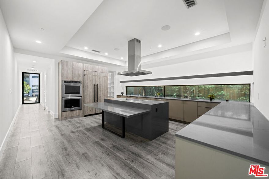 BEAUTIFUL RECENTLY BUILT 4 BED/4.5 BATH + PARKING. This private, contemporary newer-construction home is ideally situated in the highly desirable Beverlywood-adjacent neighborhood and thoughtfully designed for both leisure and modern living. Spanning approx. 3,500 sq. ft. across 3 levels, the residence offers 4 bedrooms, 4.5 bathrooms, and multiple indoor-outdoor entertaining spaces, including a stunning rooftop deck. The main level features a chef's kitchen with custom cabinetry and a generous center island with seating for five, seamlessly flowing into the expansive living and dining areas that open to a private backyard perfect for everyday living and entertaining. The second level hosts four en-suite bedrooms, including a spacious primary suite complete with a walk-in closet and a spa-inspired bathroom featuring a soaking tub, dual-sink vanity, and oversized shower. The top floor offers an additional en-suite bedroom, private deck, and an exceptional indoor-outdoor living area leading to the rooftop deck with built-in barbecue ideal setting for entertaining and enjoying city views.