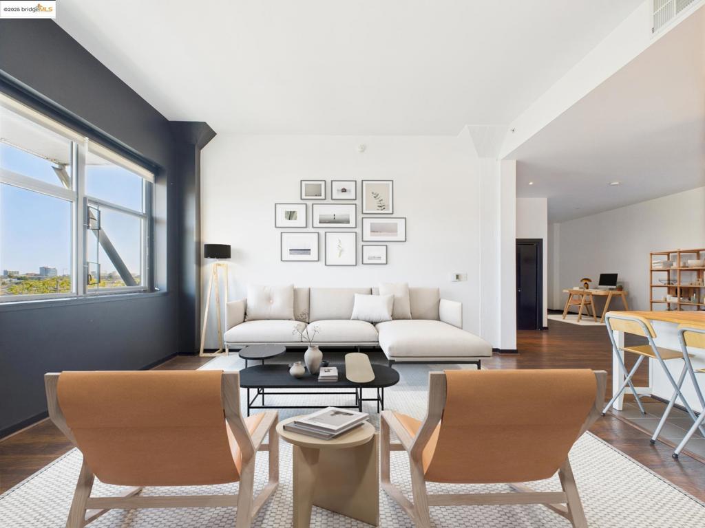 Centrally Located Modern Loft with Hill Views! Welcome to 1001 46th Street #503—a top-floor urban retreat that blends dramatic volume with sophisticated design. This 1,195 sq ft loft-style condominium impresses from the moment you step inside, with a huge wall of windows that frame serene hill views and bathe the space in natural light. High ceilings, modern finishes, and sleek lines create a true loft feel and sense of openness and calm. The open-concept layout integrates living, dining, and kitchen spaces with seamless flow. A stylish kitchen features granite countertops, stainless steel appliances, and bar seating—perfect for cooking & entertaining. Thoughtful touches like the in-unit stackable washer & dryer, one spacious enclosed bedroom, plus bonus space for second open bedroom, office, or creative space make this a very special, premium unit. This home features one generously-sized bathroom. Set within a secured building, the residence includes covered garage parking, an electric car charging area, and a fitness center just steps from your door. A central courtyard offers a peaceful shared outdoor space with a garden and peaceful fountain, ideal for relaxing or connecting with neighbors! Views: Downtown