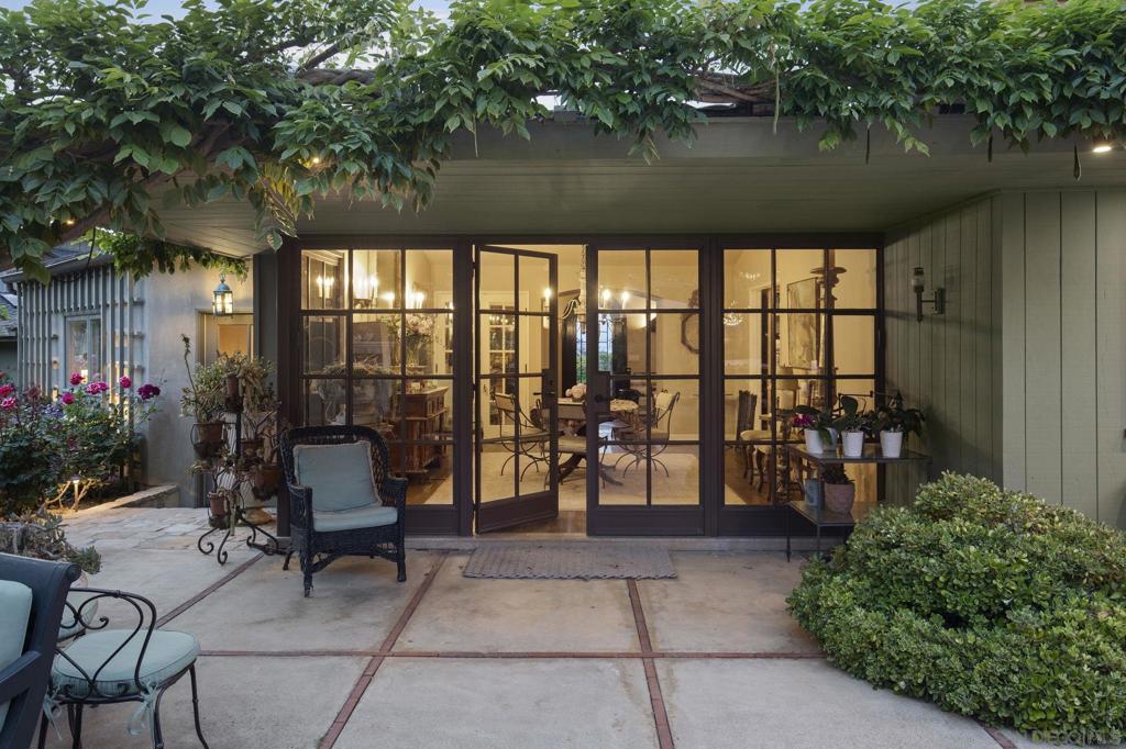 The Art of Living Well - a mid-century single level home nestled into the lower Hillside neighborhood of La Jolla, California has been home to the co-founder of award winning Island Architects for the last twenty-four years. Chosen for its ideal location and good bones, the home and gardens have been transformed into the epitome of relaxed Euro-California living. The home is a study of masterful design and function, reflecting the perfect Southern California indoor-outdoor lifestyle, on a fabulous street, close to the Village and the Shores. Imbued with timeless building materials, the home has wood and steel french doors and windows for light and easy access to the magical gardens which extend the indoor living areas into garden rooms. The three bedroom house includes a formal entry and living room with vaulted ceiling and view of the Pacific Ocean coastline, an office with fireplace, dining room and large kitchen with clerestory windows, a master retreat with sumptuous master bath and radiant floors. The master bedroom, kitchen and dining room open onto a large, gracious and very private courtyard with stone fireplace and specimen plantings. Elements from Europe have been incorporated seamlessly throughout the design of the interior and exterior of the home and include wood and steel french doors and windows, limestone fireplaces, wood beams, distinctive doors, antique terra cotta floor pavers, large olive jars, stone carved pediments, specialty lighting fixtures, all enhanced by the owner's studied use of the natural elements of space and light.