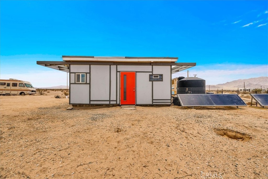 Nestled on a private 5-acre lot in sought-after Wonder Valley, this fully renovated recreational cabin is the perfect blend of smart design and modern convenience. Every detail has been thoughtfully upgraded, making the most of the 280-square-foot footprint to deliver a completely livable, turn-key space.
The cabin features a full stainless steel kitchen with an electric stove, refrigerator, and a sleek, integrated design. A built-in elevated Murphy bed maximizes floor space, while a custom built-in entertainment center adds both function and style. Comfort is ensured year-round with dual mini split systems for efficient heating and cooling, recessed LED lighting on dimmers, and dual-paned windows throughout.
Utilities are fully set up: connected electricity, a 2,500-gallon hauled water tank, and a solar panel water heater that supports both the water heater and washing machine.
Outside, the fully fenced backyard features a creatively built shed made with recycled colored wood—perfect for storage or workspace. The property is set back from the road, offering a sense of privacy while still being conveniently located just past The Palms Restaurant and minutes from Joshua Tree National Park.
This is a rare opportunity to own a fully functional and modern micro-home on a spacious desert lot—perfect for anyone seeking simplicity, self-sufficiency, and smart design. A true one-stop shop.