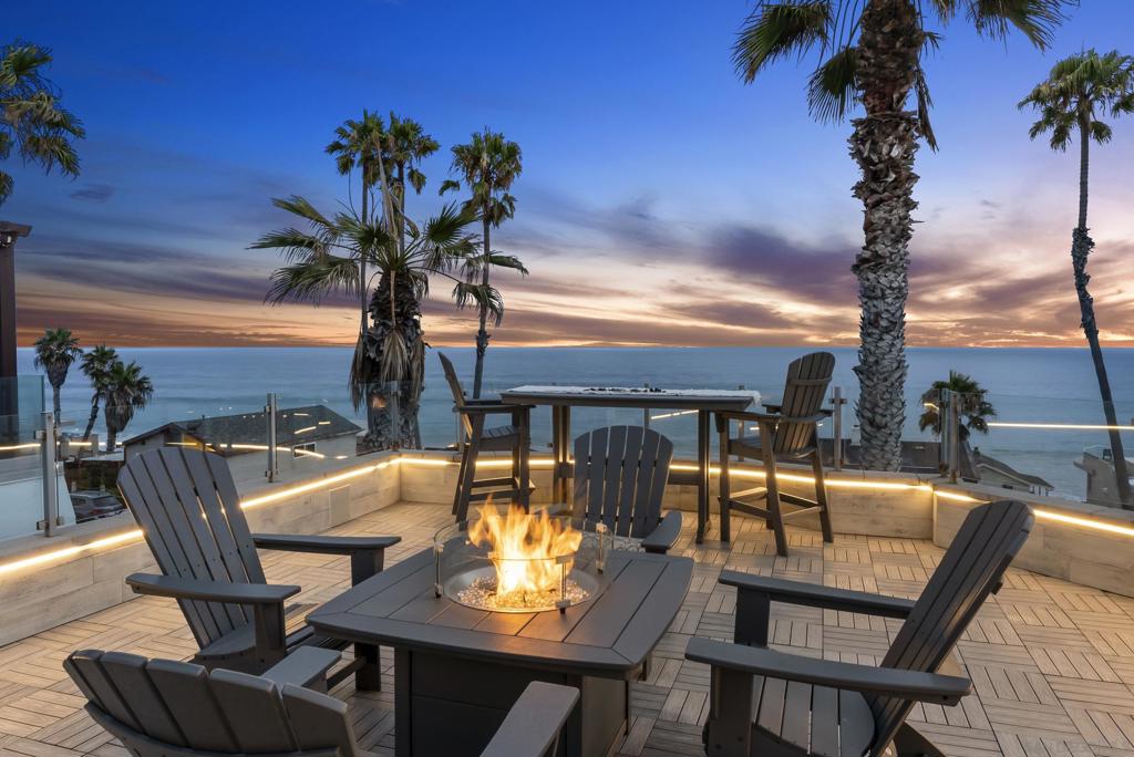 Welcome to 506 South Pacific — where luxury meets lifestyle on the edge of the Pacific. This coastal sanctuary is ideally situated just one street above The Strand, offering unobstructed panoramic ocean views and a front-row seat to the iconic Oceanside Pier from every level. Breathe in the salt air, catch rooftop sunsets, and enjoy effortless access to Michelin-rated restaurants, local cafés, and the vibrant, walkable energy of coastal Oceanside. A rare opportunity to live at the intersection of natural beauty and elevated design. This 3-bedroom, 4-bathroom, ~3,008 sq ft residence underwent a comprehensive top-to-bottom renovation in 2020, including a reimagined layout to enhance natural light, storage, and flow. Clean modern design meets timeless coastal warmth, with high-end, designer-selected finishes throughout. Highlights include a culinary showpiece kitchen, custom bathrooms including spa like primary bath with ocean view soaking tub, zoned whole-home audio, and an iconic rooftop deck that steals the show—complete with a sleek lounge and bar, perfect for golden-hour gatherings. Additional enhancements include an owned 9.2kW solar system (installed 2023), whole-house water filtration, new HVAC, a freshly coated roof, and a full home security system—enhancing the home’s lock-and-leave potential. Every inch has been thoughtfully curated and impeccably maintained, offering a rare turnkey lifestyle in one of Southern California’s most dynamic coastal enclaves. Sunsets included, nightly.