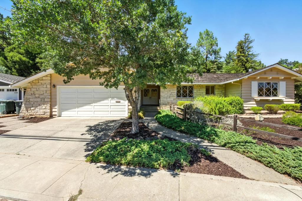 This warm and inviting 4 bedroom, 2.5 bathroom home offers over 2,000 sq ft of living space on a 10,544 sq ft lot. The formal entry opens into a spacious living room with hardwood floors, a cozy fireplace, and walls of windows that bring the outdoors in. The spacious kitchen with a large center island opens to the dining area or family room creating the perfect setting for family meals and gatherings with friends. From there, enjoy easy access to the backyard with patio and sprawling lawn. The primary suite, set down the hall, offers a true retreat with ample closet space and a dressing area. Three additional bedrooms share a full hall bath, providing flexibility for family, guests, or a home office. Everyday convenience is built in with a well-placed half bath, separate laundry room, and attached 2-car garage. Minutes from the vibrant downtown restaurants and shops. Excellent San Carlos schools! Close proximity to hiking trails, parks and major streamlined commute routes.