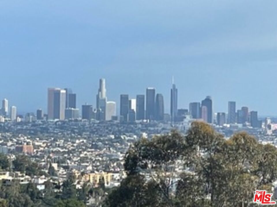 Introducing an extraordinary opportunity for Buyers, Developers and Investors - Nestled in the heart of the Hollywood Hills, boasting views that promise to captivate your senses. Originally acquired in 1969, this cherished Family estate offers a rare chance to own a piece of history - Positioned on the most coveted street in the area, this property provides unparalleled vistas, overlooking panoramas, this oversized 13,000 sq. ft. lot presents endless possibilities, including the potential for a stunning 6,000 aq. ft. home. Embrace the enchantment of daily sunrises and sunsets in a symphony of natural beauty. Conveniently located just moments from Hollywood Blvd, yet secluded enough to enjoy tranquility, this address offers the best of both worlds. Nearby amenities include a local grocery store and a popular cafe for your daily needs, while hiking and biking trails are just a stroll away, leading to iconic landmarks like Lake Hollywood and the famed Hollywood Sign. For those seeking an exceptional lifestyle, this is your Golden Opportunity