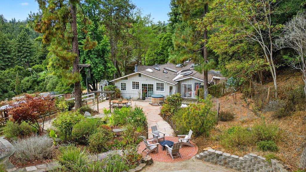 This single level, 3 bedroom / 2.5 bath home offers a detached bonus space and 2.85 acres, all with the convenience of being close to town. Take in the idyllic nature views, while sitting next to your koi pond and waterfall fountain on an incredible flagstone patio. The home offers a spacious, open concept floor plan, while featuring a primary suite with exterior access, hardwood floors, a library, pantry and ample skylights for incredible natural light. The detached bonus space offers flexibility for work, hobbies, or guests. The property is zoned agriculture and equipped with livestock pens, multiple outbuildings, plenty of paved parking, and private well producing 13 GPM. Just minutes to Aptos Village, Nisene Marks trails, Rio Del Mar Beach, and Highway 1, this property blends privacy, space, and convenience.