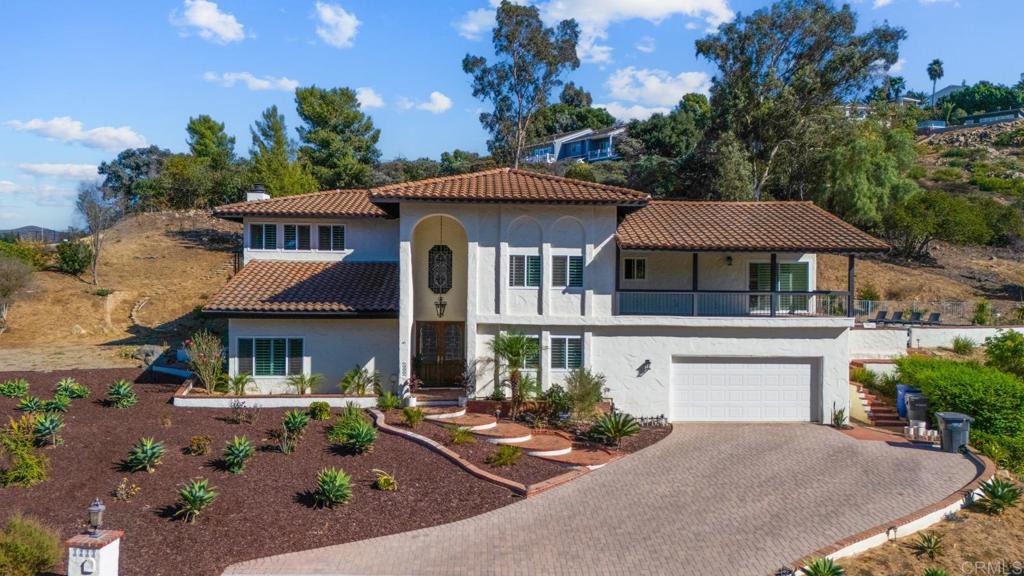 Custom Built Rancho San Diego hilltop estate with Spanish style design and modern interior upgrades! This home offers sweeping mountain views and an occasional peek view of Coronado Island from multiple balconies. Double door Entrance greets you to vaulted ceilings and a recently fully remodeled open floor-plan! The Gourmet kitchen features custom white cabinetry, quartz counter-tops, an extra-large subzero fridge, double ovens, and a large island that opens up to your nook eating area as well as the family room area! The family room offers a modern style fireplace and three sliding glass doors that take you out to the backyard area! The Backyard offers custom pool, jacuzzi, large sunbathing deck w views, covered patio area as well as plenty of room to entertain your family & guests! This expansive lot has room to build an ADU or add motor home parking if desired. Large Master-Suite offers gorgeous views, fireplace, walk-in closet completely built out & a gorgeous master bath w separate bathtub and stand-up shower! Fruit trees, including Mulberry, avocado, orange, tangelo, Peach, guava, lemon, apricot, Cheremoya and more! A large driveway suitable for six cars, paired with an oversized garage ensure you will have plenty of parking for any guests. Come live the good life in this quiet neighborhood of East County!