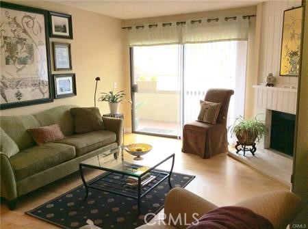 Gorgeous 1 story condo has 2br, 2ba & 2-car private garage is ready for occupancy. Beautiful laminate wood floors, big living room w/fireplace, dining area w/custom built-in china cabinet w/glass fronts. Fabulous kitchen has recessed lighting, tiled floors & counters, gas cook top, dishwasher, refrigerator, and breakfast bar. Master is huge with 2nd sink/vanity area & lots of closet space. Wash/dryer, Frig & 2 car garage, water & trash included. Balcony with additional storage closet, all windows facing south, has tankless water heater. Pools/spas, tennis courts, immaculate grounds all in the heart of Warner Center. Walk to the Village at Westfield, restaurants, markets, movies, free concerts in the parks, and much more! Non-smoking building. Photos taken while furnished, now vacant.