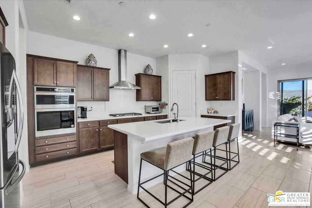 Welcome to luxury living at Del Webb Rancho Mirage's 55+ community. Nestled in phase 6, this upgraded Expedition Model Home offers a truly exceptional living experience. Step into this stunning one-level home built in 2023 and be greeted by 10-foot ceilings and panoramic mountain views. This spacious, 1770 square foot residence features two large bedrooms, two baths, and a den, providing ample space for living, relaxation and entertainment. The interior of the home was completely repainted in April of 2025. The primary bedroom boasts a large walk-in closet, dual vanities in the bath and a linen closet. The second bedroom also offers a walk-in closet, providing extra storage space. The private den offers the perfect office or reading room, located in the front of the home. With an open floor plan seamlessly connecting the kitchen, dining, and living areas, this home is perfect for hosting gatherings or enjoying quiet nights in. This home offers a spacious kitchen with ample cabinetry, a large center island and great storage with a walk-in pantry. The laundry room includes a sink for added convenience and additional shelving above. Custom finish upgrades were made during construction, including prewiring for LVR surround sound, custom tile floors throughout, wood shutters for privacy and sun protection, and owned Solar system! The backyard of this home is completely landscaped to be an entertainer's dream and low maintenance. It offers a covered patio and multiple seating areas. It's the perfect setting for hosting outdoor gatherings or simply relaxing in the sunshine. Living at Del Webb Rancho Mirage means access to an array of exceptional amenities. The 20,000 square-foot clubhouse offers a modern fitness center, aerobics studio, golf simulator, a wine room and an outdoor fireplace. The ballroom is perfect for special events and entertainment. Outdoor enthusiasts will appreciate the large pool and smaller covered pool, as well as the large spa for ultimate relaxation. Stay active with 8 Pickleball courts, 4 tennis courts, 3 bocce courts, a putting green, and six miles of walking trails. There are also dedicated dog areas for your furry friends. At Del Webb Rancho Mirage, residents can enjoy a well-organized and endless variety of activities and events tailored to their interests. It's the perfect place to create lasting memories and forge new friendships.