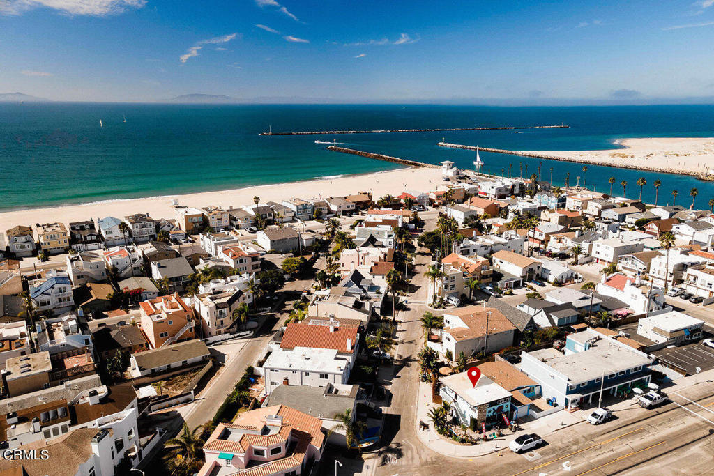 Welcome to a unique and rare opportunity at the heart of Silver Strand Beach--a landmark property that offers the perfect blend of coastal living and business potential. Imagine living just steps from the beach while operating your own business, or renting out either space for additional income.The charming upstairs residence features 2 bedrooms, 1 bathroom, and an inviting open floor plan. The rich wood ceilings and ample windows flood the space with natural light, creating a warm, airy ambiance perfect for coastal living.On the ground floor, the current gift shop is full of character with multiple creative display spaces, a countertop with a sink, and a full bathroom with a shower. This thoughtfully laid-out space has been crafted with care and offers endless possibilities for any business owner.Situated on a prime corner lot, this property naturally draws people in--whether they're looking for a special treasure in the shop or simply stopping by to say hello. The owner had lovingly transformed the outdoor space around the building into a welcoming retreat, complete with beautiful paver hardscape, lush palm trees, and a tranquil koi pond that enhances the property's charm.This well-established location awaits for the next owner to bring their vision to life in a community that truly embraces the local spirit. Whether you dream of running a beachside business, enjoying the beauty of Silver Strand Beach, or both, imagine the possibilities.