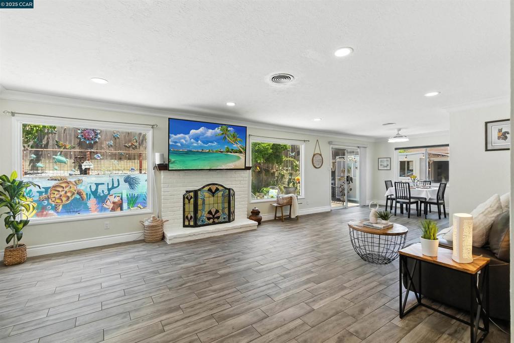 Discover this beautifully updated & truly move-in ready 3-bedroom, 2-bath single-story home, ideally positioned on a premium lot w/ a spacious, fully fenced front yard—perfect for relaxing outdoors, playing w/ pets, or enjoying extra privacy. Inside, you’ll find bright, sun-filled living spaces w/ large windows, elegant tiled flooring, & a cozy fireplace as the living room’s centerpiece. The remodeled kitchen showcases stainless steel appliances, granite tile countertops, & stylish finishes, while both bathrooms have been thoughtfully upgraded w/ modern design touches. The converted garage offers versatile space for a home office, gym, playroom, or guest retreat, giving you flexibility to suit your lifestyle. Recent improvements include a newer roof (2023), new water heater, fresh exterior paint, & an upgraded electrical panel for both efficiency and peace of mind. Additional highlights include crown molding, recessed lighting, mirrored closet doors, hardwood floors in the bedrooms, & a generous backyard complete w/ persimmon & tangerine trees plus a handy storage shed. Combining charm, functionality, & quality upgrades, this home delivers exceptional comfort in a sought-after location close to freeways, parks, schools, hospitals, and entertainment. This is truly a rare find!