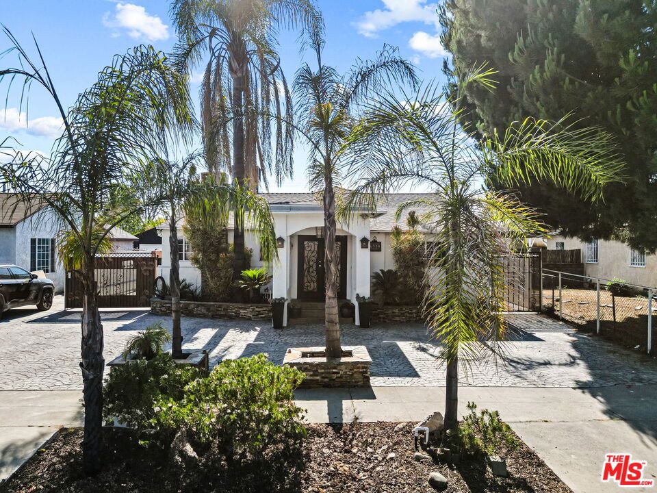 Charming Pool Home in Prime NOHO Location. Discover the potential of this inviting 3-bedroom, 3-bathroom home situated in a desirable North Hollywood neighborhood. This home effortlessly blends comfort, style, and functionalityperfect for both everyday living and entertaining guests. A charming circular driveway leads to a striking wrought iron and glass entry door that sets the tone for the elegance within. Inside, you'll find a spacious open-concept floor plan featuring a chef's kitchen with a center island, stainless steel appliances, and generous cabinetryideal for culinary creations and social gatherings. The expansive primary suite includes a cozy sitting area and double French doors that open to the serene backyard oasis, complete with a sparkling pool and lush landscapingyour private retreat for relaxation or weekend entertaining. The 3-car detached garage offers excellent potential for an ADU conversion, creating endless possibilities for guest quarters, rental income, or a home office. Don't miss this incredible opportunity to own a stylish, move-in ready home with space to grow and entertain in one of the Valley's most desirable locations.