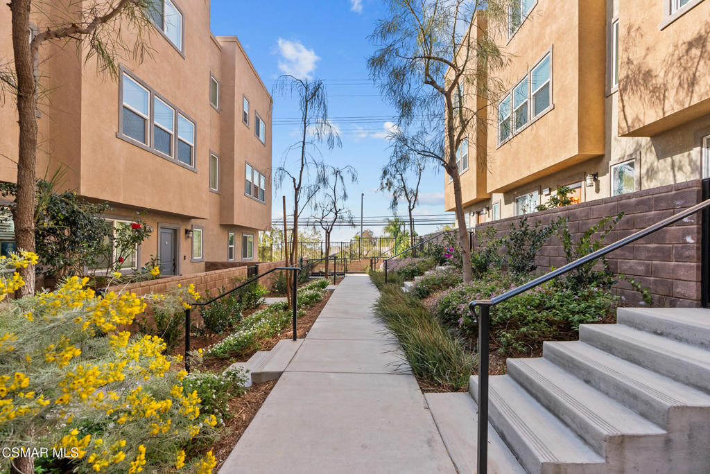 This is a home you don't want to miss! Welcome to 12745 Watt Ave, a stunning tri-level townhome nestled in a sought-after, gated community in the heart of Sylmar. This modern home, built in 2018, offers the perfect blend of privacy and convenience. As an end unit, this charming 5-bedroom, 4-bathroom, 1,920sqft residence provides ample living space with an ideal layout for both comfort and entertainment. Upon entry, you're immediately welcomed by a spacious bedroom on the first floor, complete with an updated en-suite bathroom--a perfect space for guests or multi-generational living. As you move upstairs, the open-concept kitchen and dining area are flooded with natural light, creating an inviting and airy atmosphere that is perfect for everything from casual family meals to entertaining friends. The home continues to impress with a full bathroom and a separate bedroom on this level, offering flexibility as an additional guest suite, home office, or creative space. As you ascend to the third floor, you'll find three generously sized bedrooms, including a luxurious primary suite with a beautifully updated bathroom featuring dual vanities and a walk-in closet. This floor also includes a convenient laundry room and another updated full bathroom for added comfort and functionality. Step outside to the private patio area, ideal for enjoying a morning coffee or hosting an evening BBQ with friends and family. The attached 2-car garage ensures easy parking, and ample guest parking is available throughout the community. Community amenities abound, with a dog park, pool, playground, and picnic areas, making it a perfect place to relax and unwind. This home boasts numerous upgrades, including recessed lighting, dual-pane windows, and vinyl wood flooring throughout, elevating both the aesthetic appeal and energy efficiency. Conveniently located near top shopping destinations like Target, dining spots like Jersey Mike's Subs and Starbucks, and just minutes away from major freeways, this home combines luxury, comfort, and accessibility. Additionally, this home is close to the popular college, Los Angeles Mission College as well as other schools like PUC Community Charter Elementary School and Sylmar High School. Don't miss the chance to own this incredible home--come experience the perfect blend of modern living and privacy at 12745 Watt Ave!