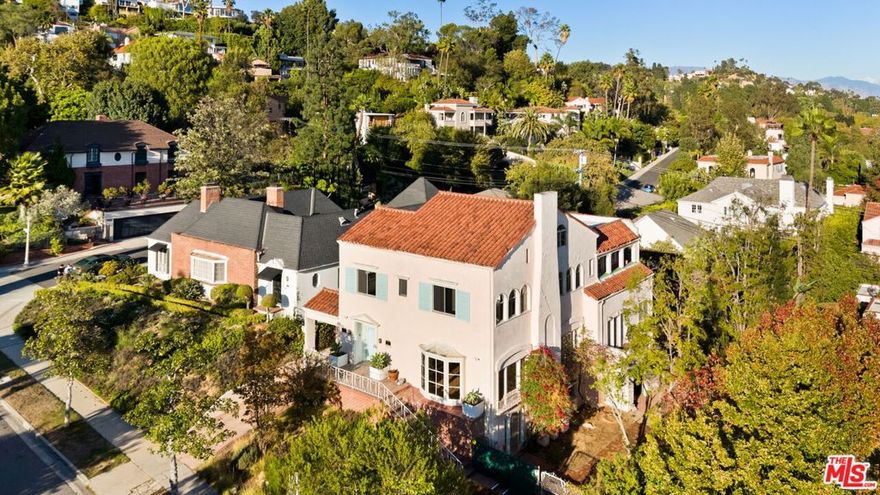 Step into Hollywood history with the childhood home of beloved actress June Lockhart. Nestled north of Los Feliz Boulevard, this enchanting Spanish Colonial Revival residence captures timeless character and sweeping views from the ocean to the mountains.With six bedrooms including five conveniently located on the same level and five bathrooms, this home blends classic architecture with exceptional livability. Expansive living and dining rooms set the stage for grand entertaining, while the kitchen offers exciting potential to expand into a sunny breakfast nook.Outside, a sprawling flat yard unfolds with a large pool, a badminton/sports court, and ample space for recreation and relaxation. Rarely does a property combine such storied provenance, generous scale, and breathtaking vistasall in one of Los Angeles' most coveted neighborhoods.
