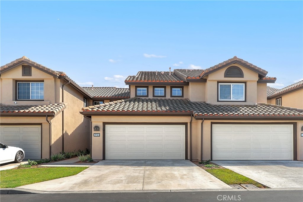 Welcome to 60 Meadowbrook, an immaculate home in the heart of Aliso Viejo. The inviting family room features a stylish accent wall and cozy fireplace, seamlessly opening to the dining area and kitchen. The kitchen boasts white cabinetry, quartz countertops with matching backsplash, stainless steel appliances, and direct access to the two-car attached garage with an extended driveway for extra parking. Sliding glass doors lead to a spacious and private backyard with low-maintenance artificial grass, perfect for entertaining or relaxing. A beautifully remodeled powder room completes the main level. Upstairs, the primary suite offers vaulted ceilings and a remodeled ensuite bathroom with a quartz vanity and walk-in shower. Two additional bedrooms share a remodeled full hall bathroom. Centrally located near Aliso Viejo Town Center, the 73 Toll Road, scenic trails, award-winning schools, and just a short drive to the beach—this home truly has it all!
