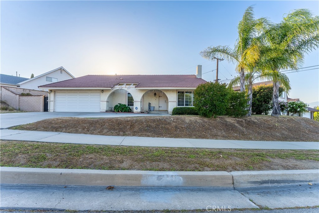 Located in the highly desirable area of Hacienda Heights, this beautiful Spanish style home with tile roof has been lovingly maintained. The 4 bedroom, 2 bath single-level home has a living area of 1909 square feet on a 9,722 square foot lot with a view of the San Gabriel mountains. As you enter the ceramic tiled foyer, the formal living room is warm and inviting with natural light, a brick fireplace, cathedral ceilings and a formal dining room. The wood laminate flooring is throughout the living room, family room, hallways, bedrooms and closets. The spacious family room with cathedral ceilings is next to the open kithchen and has direct access to the large backyard with covered patio. All windows and doors are double paned and have new faux wood blinds throughout. Additional improvements include a new a/c unit, a new water heater, and recessed lighting in the kitchen and bathrooms. The attached 2-car garage has direct interior access and an insulated garage door. Thomas Burton Park is within walking distance. And close by there is shopping, dining, the AMC movie theater and the 60 frwy.
