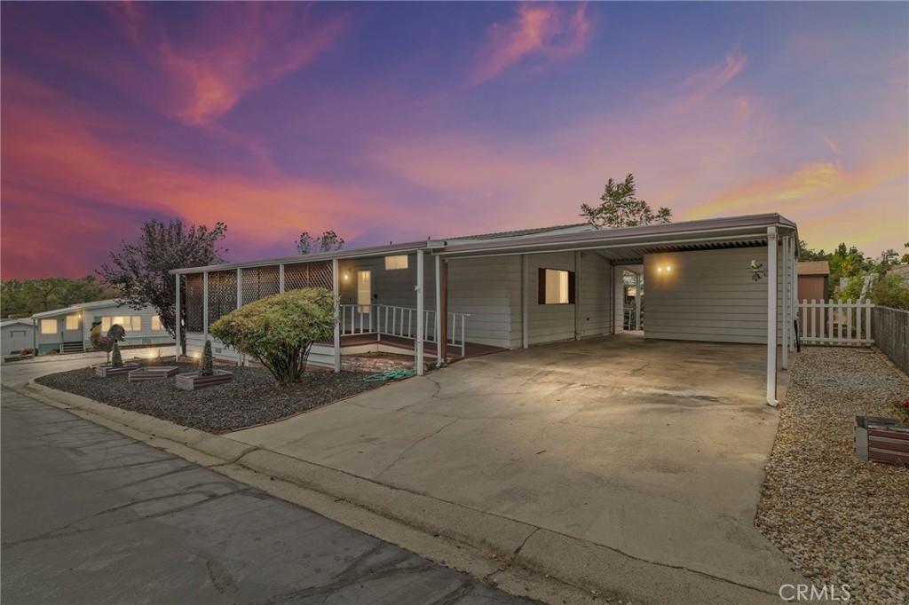 Welcome to Carriage Manor, one of Oroville’s most desirable 55+ adult communities where you own the land and enjoy no space rent! This well-maintained 3-bedroom, 2-bathroom manufactured home, built in 1985, offers approx. 1,512 sq. ft. of single-level living on a 4,356 sq. ft. lot. The home sits on a permanent 433A foundation, making it eligible for traditional financing. Inside, you’ll find an open floor plan with a spacious living area, dual-pane windows throughout, ceiling fans in every room, updated nickel-plated kitchen appliances, and a separate laundry room with washer, dryer, and standalone upright freezer included. The primary suite offers a private en-suite with a walk-in shower, while the inviting layout is designed for both everyday comfort and entertaining. Outside, a covered full-length patio provides the perfect spot to relax and enjoy the peaceful setting, while the low-maintenance yard, small garden area, and accessible ramps to both entrances add convenience. Additional highlights include a covered carport with two parking spaces, two storage sheds, and an HVAC system for year-round comfort. Carriage Manor is a well-established 55+ adult community offering a clubhouse, pool, and optional RV storage—ideal for those looking to downsize and enjoy a vibrant yet low-maintenance lifestyle.