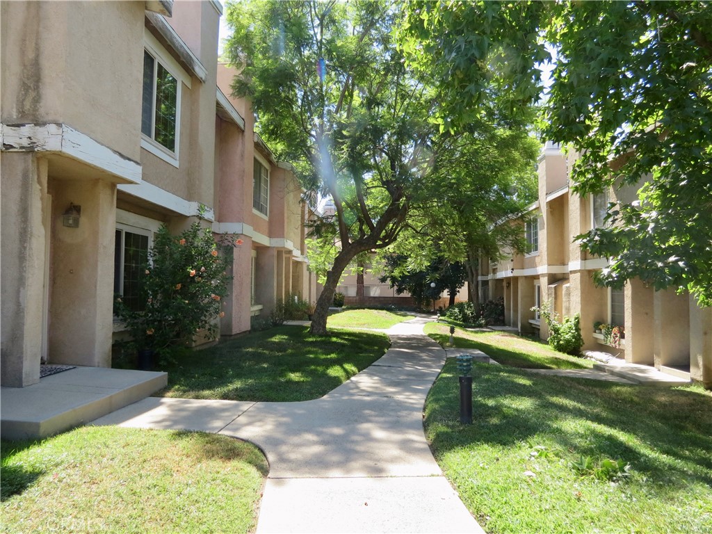 Sylmar Townhome! Aggresssively priced, needs a fresh coat of interior paint." Brand-new waterproof laminate wood floors extend through the entire home along with new toilets. Community pool access, private yard retreat, plus a detached two-car garage. Conveniently situated in Sylmar, offers easy access to major freeways including the 210, 5, and 118—ideal for commuters heading to Burbank, Pasadena, or Downtown LA. Nearby are a variety of shopping centers, restaurants, schools, and outdoor recreational spaces, including El Cariso Park and the Angeles National Forest.